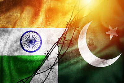 Pop Art Rights Managed Images - Grunge flags of India and Pakistan divided by barb wire sun haze Royalty-Free Image by Brch Photography