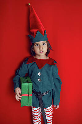 Frog Photography Rights Managed Images - boy child in a dwarf costume stands on red background on Christmas Day Royalty-Free Image by Elena Saulich