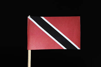 Football Royalty Free Images - A official and original flag of Trinidad and Tobago on the toothpick on black background. A red field with a white edged black diagonal band from the upper hoist side to the lower fly side Royalty-Free Image by Vaclav Sonnek