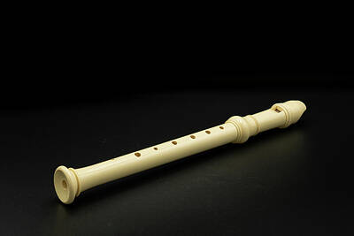 Nighttime Street Photography Rights Managed Images - A plastic soprano recorder lying on black background Royalty-Free Image by Stefan Rotter