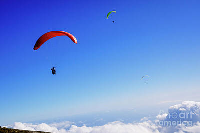 Athletes Photos - Athletes use an ultralight flexible glider, paraglider, to fly a by Joaquin Corbalan