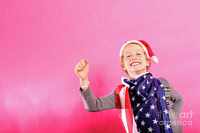 Politicians Rights Managed Images - Blond boy with santa hat, American flag and raised fist in victo Royalty-Free Image by Joaquin Corbalan