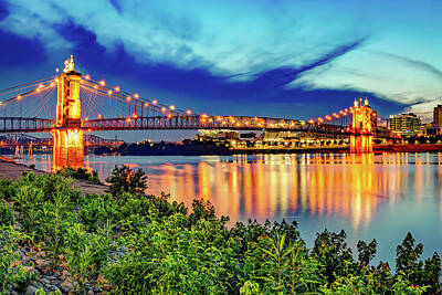 Football Royalty-Free and Rights-Managed Images - Cincinnati John A. Roebling Bridge at Dusk Along The Ohio River Shoreline by Gregory Ballos