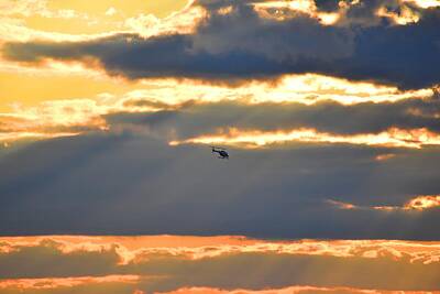 Spaces Images - Helicopter in the Sunset over NYC Harbor by Nina Kindred