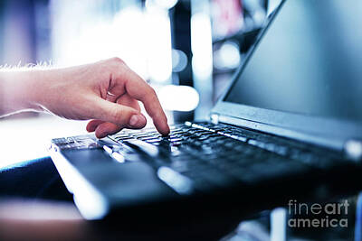 Aretha Franklin - IT specialist pressing button on keyboard in big data center. by Michal Bednarek