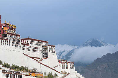 Mountain Rights Managed Images - Lhasa Potala Palace against cloud- and snow-covered mountains Royalty-Free Image by Eckart Mayer Photography