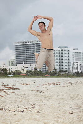 Beach Photos - Midair capture of a man jumping by Felix Mizioznikov