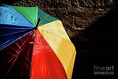 Modern Feathers Art Royalty Free Images - Open umbrella against the intense sun with bright colors and dar Royalty-Free Image by Joaquin Corbalan
