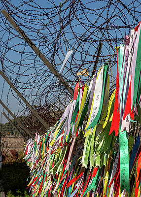 Cowboy - Prayer ribbons attached to a barb wire fence at the Korean Demilitarized Zone by Snap-T Photography