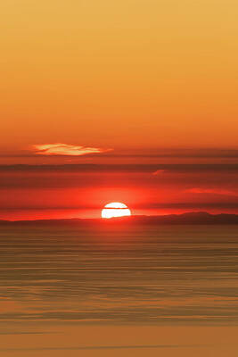 Halloween Movies Rights Managed Images - Sun setting behind the coast of France Royalty-Free Image by Jon Ingall