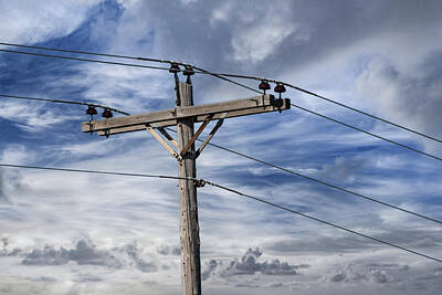 Randall Nyhof Royalty Free Images - Utility Pole against a Cloudy Blue Sky Royalty-Free Image by Randall Nyhof