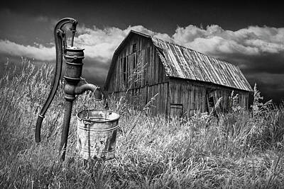 Randall Nyhof Royalty-Free and Rights-Managed Images - Weathered Wooden Barn with Water Pump and Metal Bucket in Black and White  by Randall Nyhof