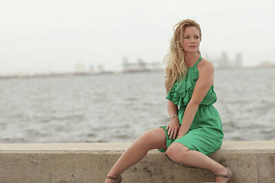 City Scenes Photos - Woman sitting by the bay in a green dress by Felix Mizioznikov