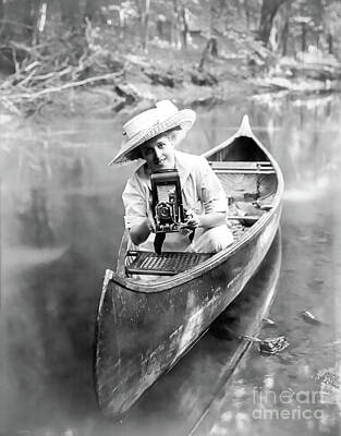 City Scenes Photos -  young  Edwardian woman sits in a canoe, pointing a camera by Sad Hill - Bizarre Los Angeles Archive