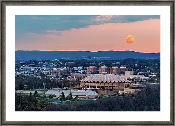 Super pink moon rises above the WVU Coliseum in Morgantown WV